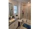Bright bathroom featuring a granite vanity, shower, and toilet at 5131 Forum Blvd, Holiday, FL 34690