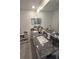 Bathroom featuring granite countertop, double sinks, decorative mirror, and white cabinets at 5131 Forum Blvd, Holiday, FL 34690