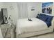 Comfortable bedroom showcasing white bedding, coastal art, and a decorative vanity at 5131 Forum Blvd, Holiday, FL 34690