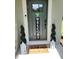 Charming front door with welcome mat, festive decor, and potted spiral topiary trees at 5131 Forum Blvd, Holiday, FL 34690