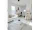 Bright living room with white sectional, decorative pillows, and stylish decor on shelves at 5131 Forum Blvd, Holiday, FL 34690