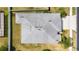 Aerial view of home with well-maintained gray roof, landscaping and large backyard at 5453 Suncatcher Dr, Wesley Chapel, FL 33545