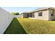 Spacious backyard with lush green grass and white fencing, offering ample outdoor space at 5453 Suncatcher Dr, Wesley Chapel, FL 33545