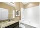 Bathroom showcasing granite counters, a tub with shower, and ample lighting at 5453 Suncatcher Dr, Wesley Chapel, FL 33545