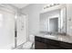 Modern bathroom with glass shower, granite countertop, and dark wood cabinets at 5453 Suncatcher Dr, Wesley Chapel, FL 33545