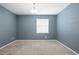 Comfortable carpeted bedroom with neutral walls and a bright window at 5453 Suncatcher Dr, Wesley Chapel, FL 33545