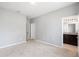 Spacious bedroom with neutral paint, carpet, and adjoining bathroom at 5453 Suncatcher Dr, Wesley Chapel, FL 33545