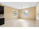 Bright dining area with natural light, tile flooring, and a modern chandelier at 5453 Suncatcher Dr, Wesley Chapel, FL 33545
