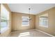 A bright dining room with tile flooring and natural light from two windows at 5453 Suncatcher Dr, Wesley Chapel, FL 33545