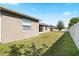 Exterior view of home showcasing a large, well-maintained backyard with green grass at 5453 Suncatcher Dr, Wesley Chapel, FL 33545