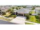 Aerial shot of a well-maintained home, green lawn, and lush landscaping at 5453 Suncatcher Dr, Wesley Chapel, FL 33545