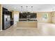 Open kitchen with a large island, stainless steel appliances, and dark cabinetry at 5453 Suncatcher Dr, Wesley Chapel, FL 33545