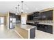 Beautiful kitchen featuring granite countertops, stainless steel appliances, and dark wood cabinetry at 5453 Suncatcher Dr, Wesley Chapel, FL 33545