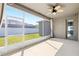 Enclosed lanai offering outdoor living space with a ceiling fan and string lights at 5453 Suncatcher Dr, Wesley Chapel, FL 33545