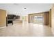 Open-concept living area with tile floors, seamlessly connected to the kitchen and outdoor patio at 5453 Suncatcher Dr, Wesley Chapel, FL 33545