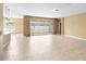 Spacious living room with tile floors and sliding glass doors leading to the lanai at 5453 Suncatcher Dr, Wesley Chapel, FL 33545