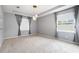 Bedroom featuring carpet, neutral walls, tray ceiling and decorative lighting at 5453 Suncatcher Dr, Wesley Chapel, FL 33545