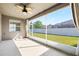 Enclosed patio features a ceiling fan and overlooks the spacious, fenced backyard at 5453 Suncatcher Dr, Wesley Chapel, FL 33545