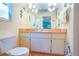 Functional bathroom featuring a vanity with a sink, a toilet, and decorative accents at 55 Squire Ct, Dunedin, FL 34698