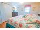 Bright bedroom featuring laminate flooring, closet, and a bed with colorful starfish quilt at 55 Squire Ct, Dunedin, FL 34698