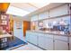 Spacious kitchen featuring ample counter space, white cabinetry, and a view of the living area at 55 Squire Ct, Dunedin, FL 34698