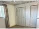 Bedroom with a neutral color palette featuring a window, curtains and a double closet at 5660 80Th N St # A102, St Petersburg, FL 33709