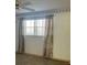 Bedroom with a neutral color palette and light-filtering curtains for enhanced privacy at 5660 80Th N St # A102, St Petersburg, FL 33709