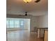 Living room area with hardwood floors, lots of natural light and an exterior door to the outside at 5660 80Th N St # A102, St Petersburg, FL 33709