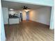 The open-concept living room features sleek hardwood floors, a ceiling fan, and seamlessly connects to the kitchen at 5660 80Th N St # A102, St Petersburg, FL 33709