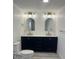Modern bathroom with dual sinks, arched mirrors, and stylish gold fixtures at 6136 56Th N Ave, St Petersburg, FL 33709