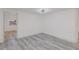 Bedroom featuring light gray wood-look floors and pristine white walls, offering a clean, modern aesthetic at 6136 56Th N Ave, St Petersburg, FL 33709