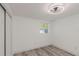 Bright bedroom with light gray wood-look floors, white walls and a window at 6136 56Th N Ave, St Petersburg, FL 33709