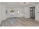 Bright bedroom featuring wood-look flooring, natural light, and a modern ceiling fan at 6136 56Th N Ave, St Petersburg, FL 33709