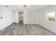 Bright bedroom with light gray wood-look floors, white walls, closet and modern ceiling fan at 6136 56Th N Ave, St Petersburg, FL 33709