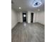 Spacious bedroom with grey wood-look floors, two closets and white walls and trim at 6136 56Th N Ave, St Petersburg, FL 33709