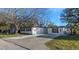 Charming single-story home with a well-maintained lawn and a concrete driveway at 6136 56Th N Ave, St Petersburg, FL 33709