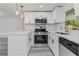 Well-equipped kitchen featuring stainless steel appliances, quartz countertop, and modern fixtures at 6136 56Th N Ave, St Petersburg, FL 33709