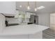 Bright kitchen featuring white cabinets, quartz countertops, stainless steel appliances and modern pendant lighting at 6136 56Th N Ave, St Petersburg, FL 33709