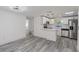 Modern open-concept kitchen with sleek white cabinets and stainless steel appliances at 6136 56Th N Ave, St Petersburg, FL 33709