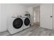 Laundry room equipped with modern washer and dryer, with neutral floors and white doorframes at 6136 56Th N Ave, St Petersburg, FL 33709