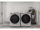 Bright laundry area includes a modern washer, dryer, and water heater at 6136 56Th N Ave, St Petersburg, FL 33709