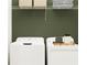 Practical laundry area with white appliances, shelving, and ample space for storage at 6472 Top Hill Dr, New Port Richey, FL 34655
