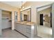 Elegant bathroom featuring a double sink vanity, decorative mirror and closet space at 713 Dorado Ct, Brandon, FL 33511