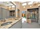 Luxurious bathroom with double sinks, granite countertops and outdoor pool access at 713 Dorado Ct, Brandon, FL 33511