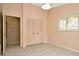 Bright bedroom showcasing tile flooring, shuttered windows, and a convenient closet for storage at 713 Dorado Ct, Brandon, FL 33511