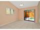 Neutral bedroom featuring tile floors, shuttered windows, and sliding doors to a private outdoor area at 713 Dorado Ct, Brandon, FL 33511