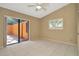 Bright bedroom with tile floors, shuttered window, and sliding glass door to private patio at 713 Dorado Ct, Brandon, FL 33511