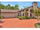 Inviting single-Gathering home with a 2-car garage, chimney, mature landscaping, and a red brick driveway at 713 Dorado Ct, Brandon, FL 33511