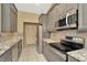Well-equipped kitchen with stainless steel appliances, grey cabinets, and ample counter space at 713 Dorado Ct, Brandon, FL 33511