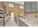 Modern kitchen featuring gray cabinetry, granite countertops, mosaic backsplash, and stainless steel appliances at 713 Dorado Ct, Brandon, FL 33511